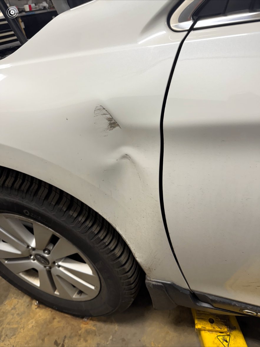 Front left fender — SUV before repair